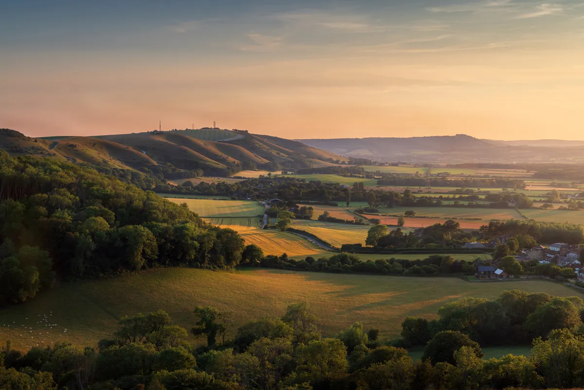 Rolling patchwork fields and hills viewed from Saddlescombe looking toward Devil's Dyke in West Sussex